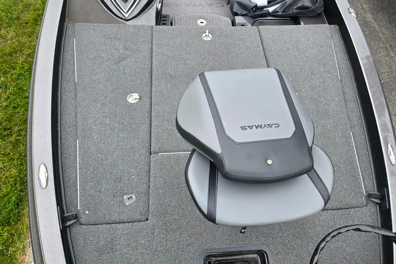 Slide: The Image of 2022 Caymas CX 19 boat interior with gray seating and storage compartments. - 19