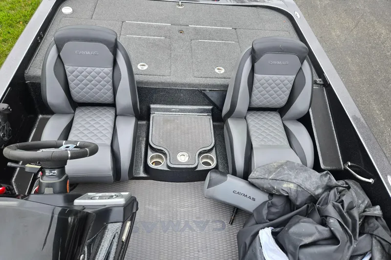 Slide: The Image of 2022 Caymas CX 19 boat interior with dual seats and steering wheel. - 21
