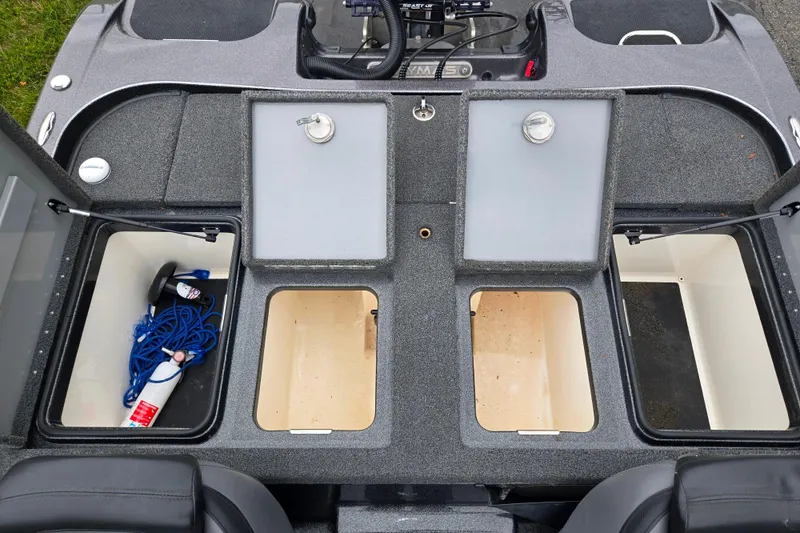Slide: The Image of 2022 Caymas CX 19 boat storage compartments with open lids, showcasing interior space and equipment. - 23