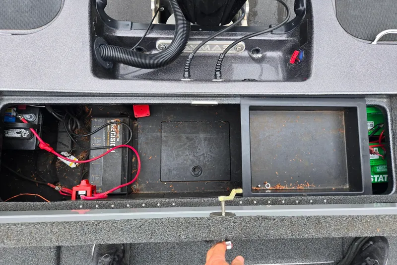 Slide: The Image of 2022 Caymas CX 19 boat battery compartment with wiring and storage spaces. - 24