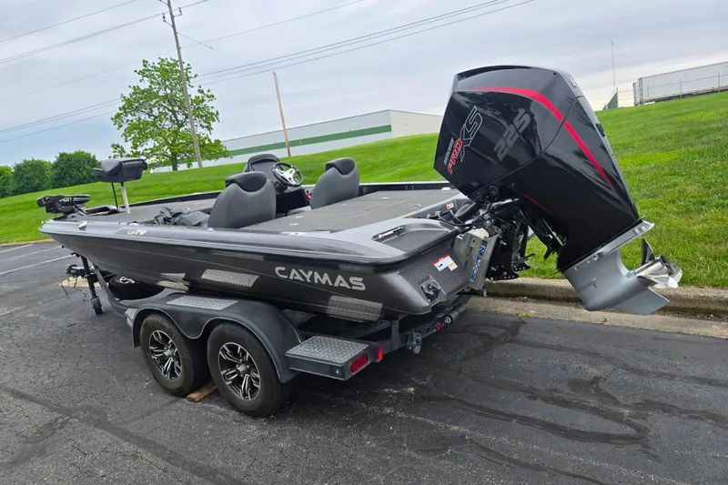 Slide: The Image of 2022 Caymas CX 19 boat with powerful engine on a trailer in a parking lot. - 3