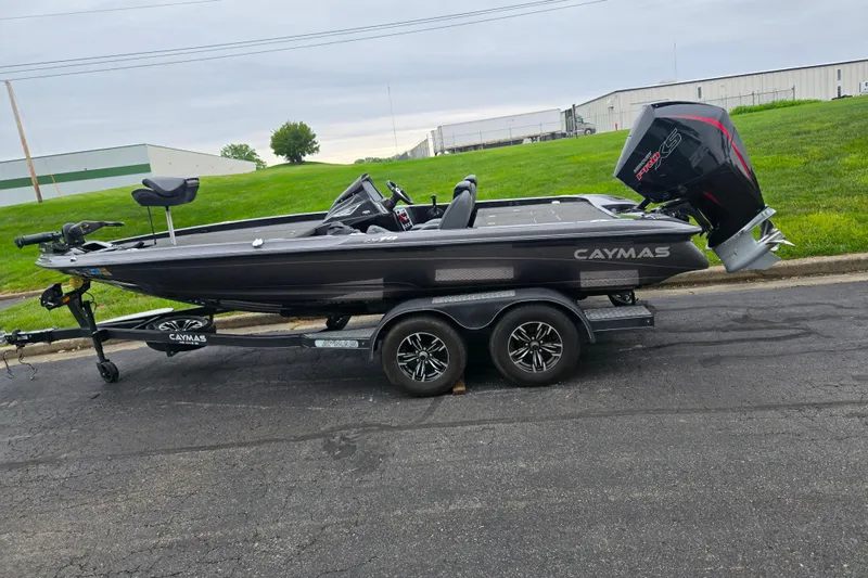 Slide: The Image of 2022 Caymas CX 19 boat on trailer, parked on asphalt near grassy area. - 4