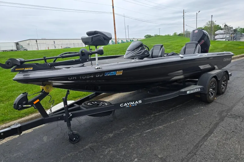 Slide: The Image of 2022 Caymas CX 19 boat on trailer, parked on pavement with grassy background. - 5