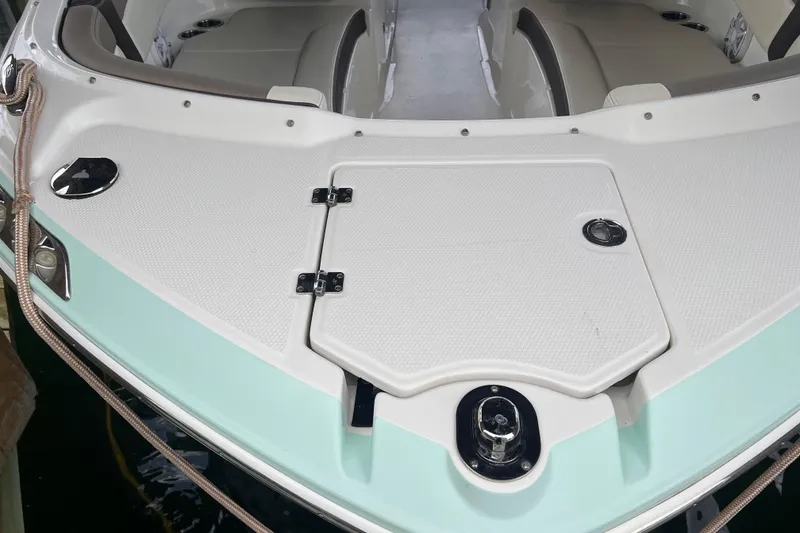 Slide: The Image of 2019 Chaparral 250 Suncoast boat deck with seating and storage compartments. - 11