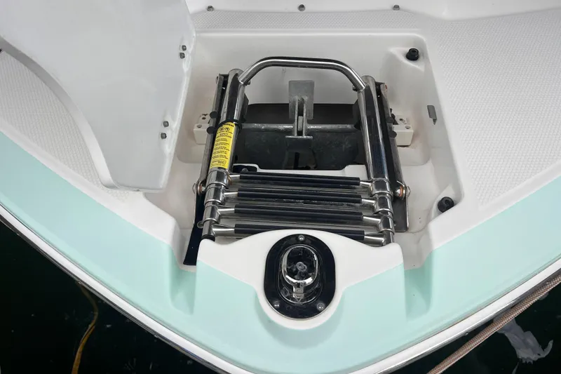 Slide: The Image of 2019 Chaparral 250 Suncoast boat anchor and ladder compartment detail. - 13