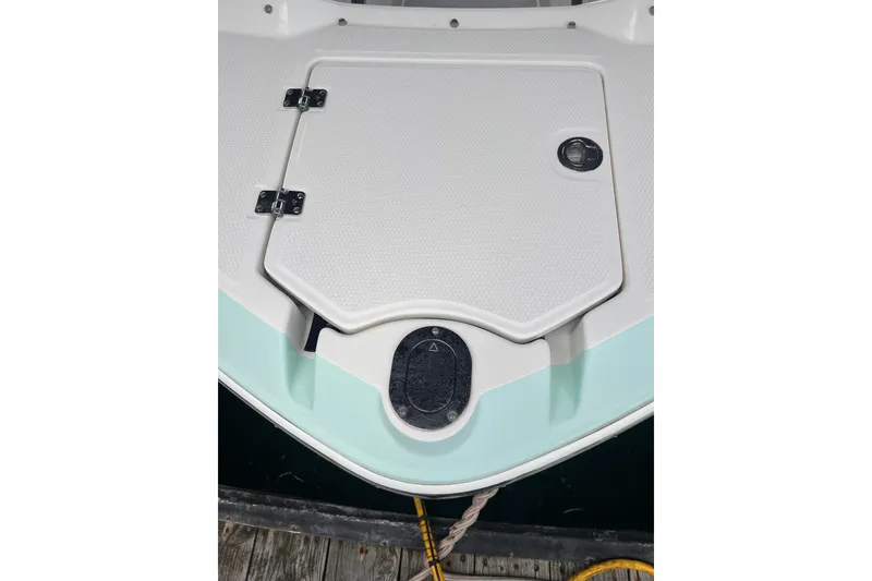 Slide: The Image of 2019 Chaparral 250 Suncoast boat deck with storage hatch and hinges. - 16