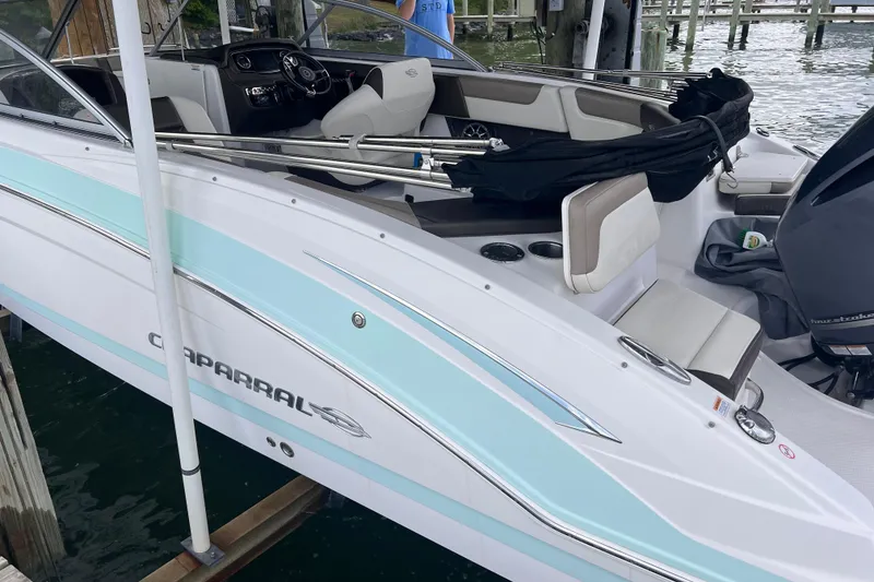 Slide: The Image of 2019 Chaparral 250 Suncoast boat docked, featuring sleek design and comfortable seating. - 17