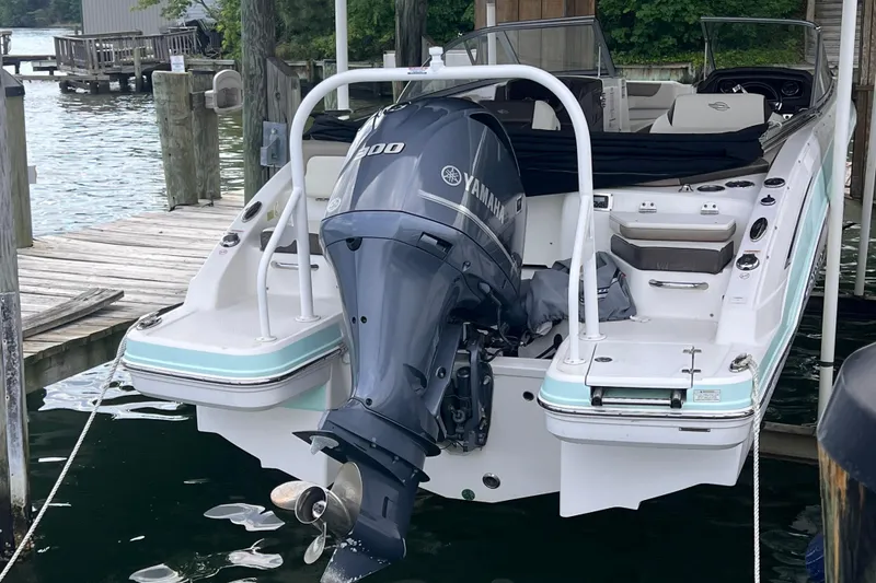 Slide: The Image of 2019 Chaparral 250 Suncoast boat with Yamaha engine docked by the water. - 19