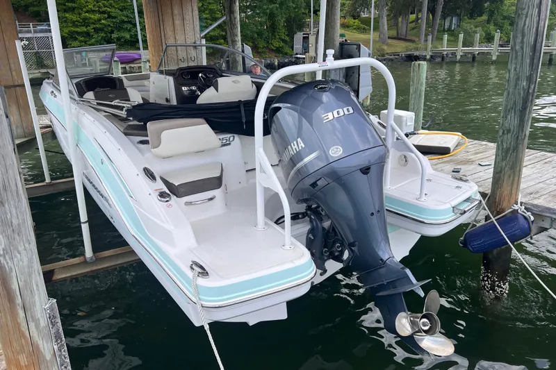 Slide: The Image of 2019 Chaparral 250 Suncoast boat with Yamaha 300 engine docked by the water. - 20