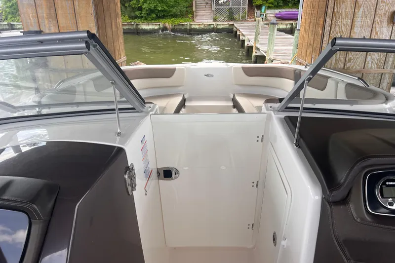Slide: The Image of 2019 Chaparral 250 Suncoast boat interior with open windshield and seating area. - 27