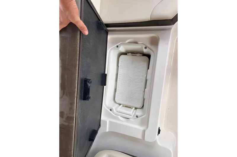 Slide: The Image of Storage compartment in a 2019 Chaparral 250 Suncoast boat, featuring a built-in cooler. - 31