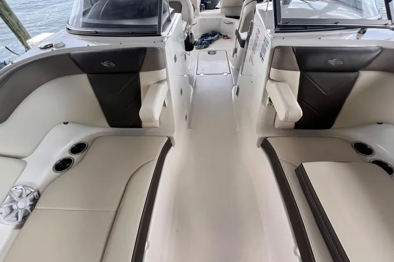 Slide: The Image of 2019 Chaparral 250 Suncoast boat interior with spacious seating and cup holders. - 36