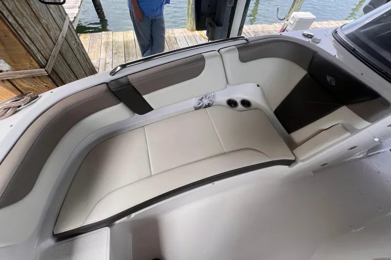 Slide: The Image of 2019 Chaparral 250 Suncoast boat interior with beige seating and cup holders. - 39