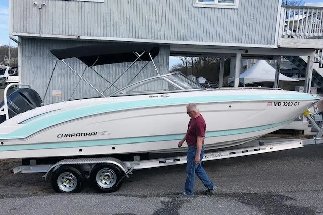 Slide: The Image of 2019 Chaparral 250 Suncoast boat on trailer, parked near a building. - 4