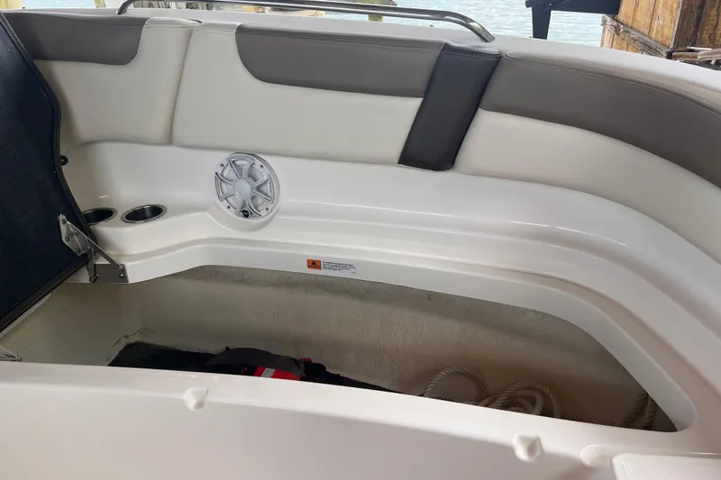 Slide: The Image of 2019 Chaparral 250 Suncoast boat interior with storage compartment and speaker. - 40