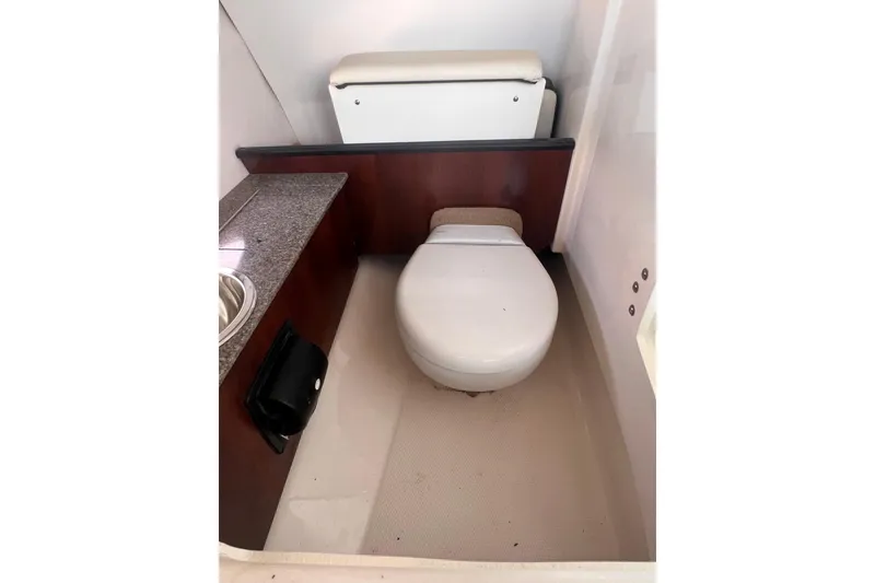 Slide: The Image of 2019 Chaparral 250 Suncoast boat interior bathroom with toilet and sink. - 42