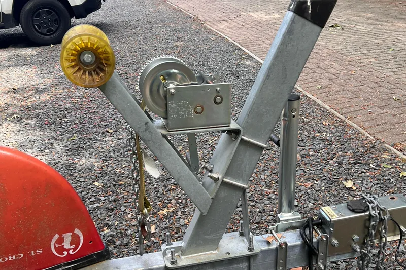 Slide: The Image of Trailer hitch and winch system for 2019 Chaparral 250 Suncoast boat on gravel surface. - 46