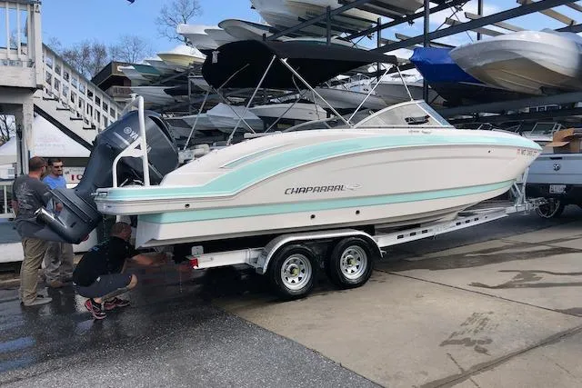 Slide: The Image of 2019 Chaparral 250 Suncoast boat on trailer, dockside with people inspecting. - 5