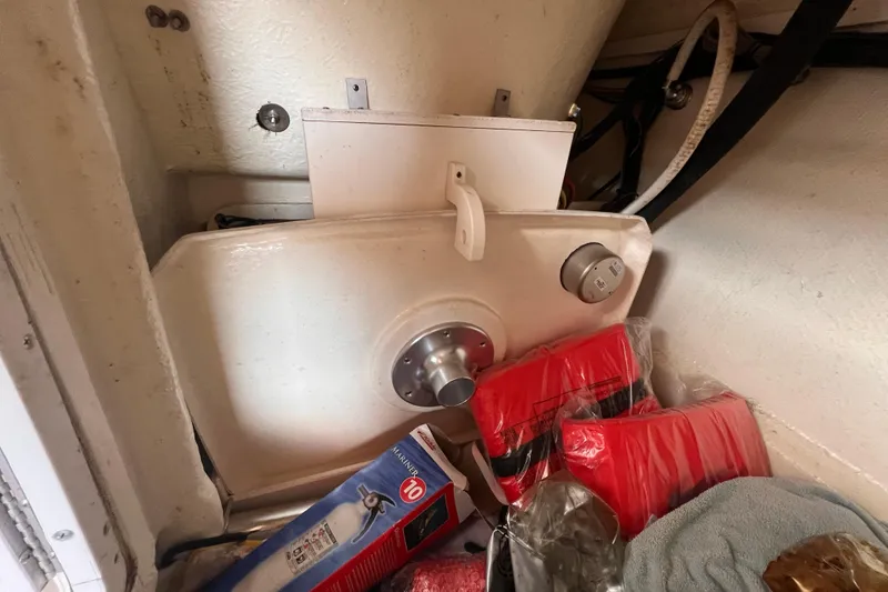 Slide: The Image of Storage compartment in a 2019 Chaparral 250 Suncoast boat with safety equipment. - 51