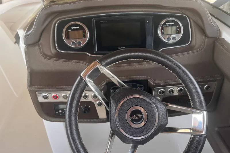 Slide: The Image of Steering wheel and dashboard of 2019 Chaparral 250 Suncoast boat with Yamaha gauges. - 57