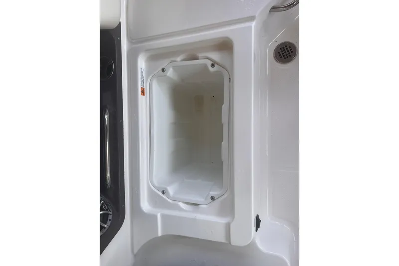 Slide: The Image of Storage compartment on 2019 Chaparral 250 Suncoast boat, featuring a sleek white interior design. - 58