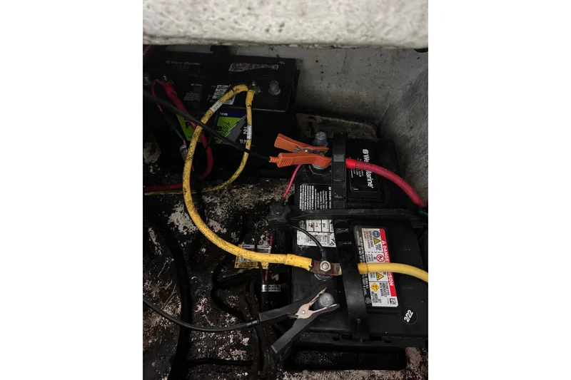 Slide: The Image of Batteries and cables in a 2019 Chaparral 250 Suncoast boat engine compartment. - 61