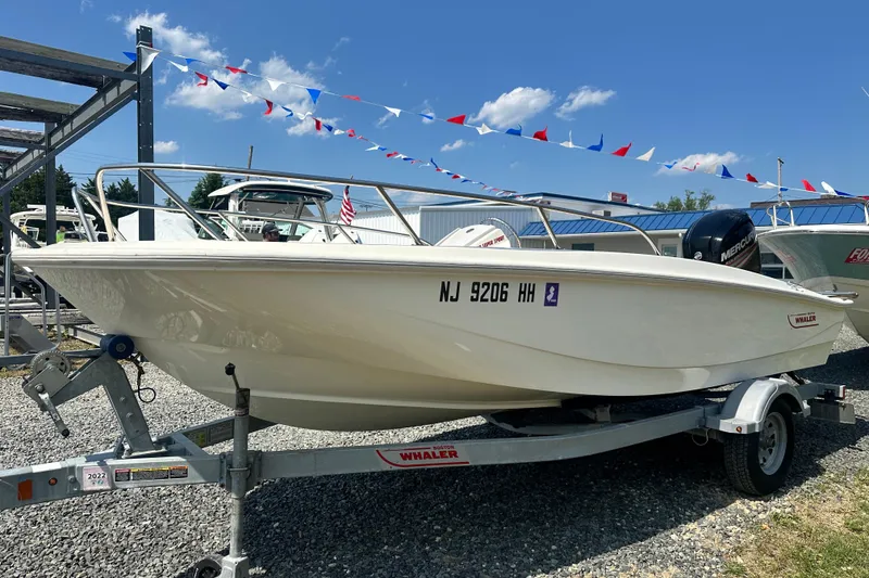 Slide: The Image of 2019 Boston Whaler 160 Super Sport boat on trailer, displayed outdoors. - 2