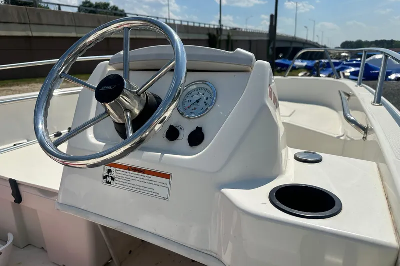 Slide: The Image of 2019 Boston Whaler 160 Super Sport boat dashboard with steering wheel and gauge. - 5