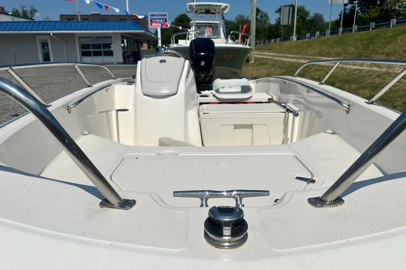 Slide: The Image of 2019 Boston Whaler 160 Super Sport boat interior with seating and railing. - 7