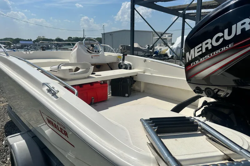 Slide: The Image of 2019 Boston Whaler 160 Super Sport boat with Mercury FourStroke engine, docked outdoors. - 8