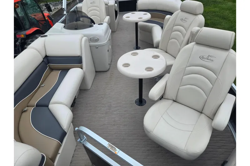 Slide: The Image of 2012 Misty Harbor 2285 Biscayne Bay RL pontoon boat interior with plush seating and tables. - 10