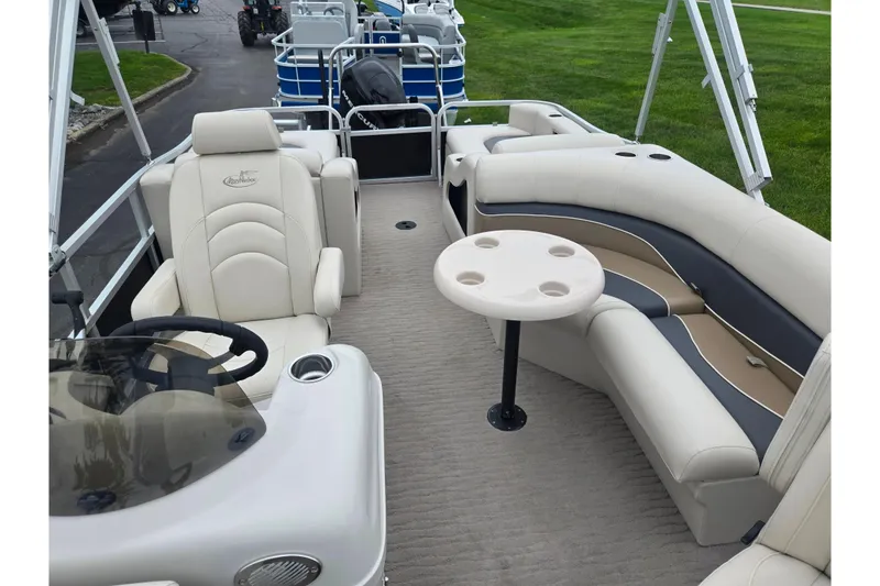 Slide: The Image of 2012 Misty Harbor 2285 Biscayne Bay RL pontoon boat interior with plush seating and steering console. - 12