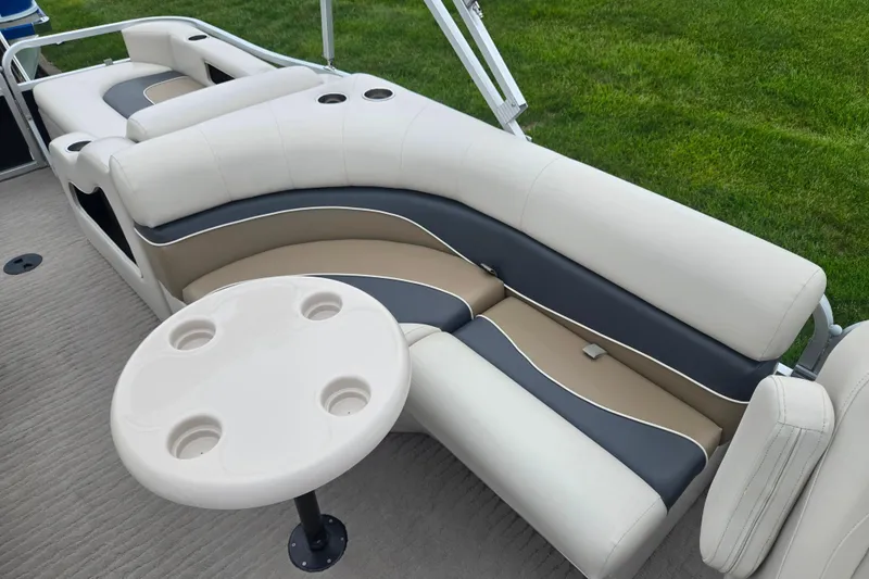 Slide: The Image of 2012 Misty Harbor 2285 Biscayne Bay RL boat interior with beige and gray seating. - 13