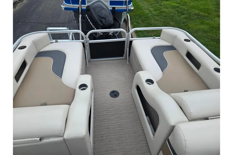 Slide: The Image of 2012 Misty Harbor 2285 Biscayne Bay RL pontoon boat interior with beige seating and cup holders. - 16