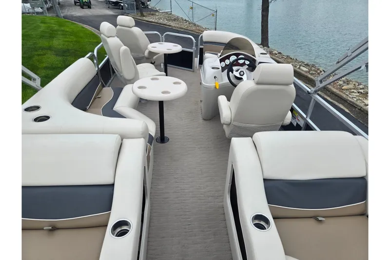 Slide: The Image of 2012 Misty Harbor 2285 Biscayne Bay RL pontoon boat interior with plush seating and steering console. - 18