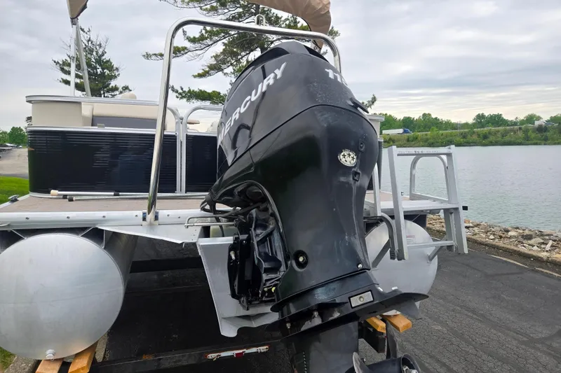 Slide: The Image of 2012 Misty Harbor 2285 Biscayne Bay RL pontoon boat with Mercury outboard motor by a lake. - 2