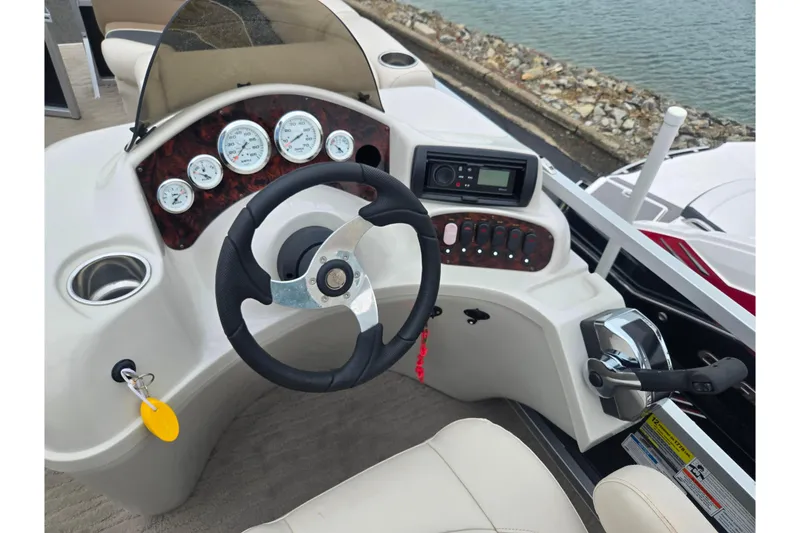 Slide: The Image of Steering console of 2012 Misty Harbor 2285 Biscayne Bay RL boat with gauges and controls. - 21