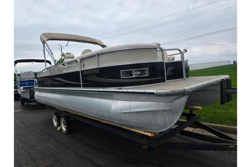 Slide: The Image of 2012 Misty Harbor 2285 Biscayne Bay RL pontoon boat on trailer, overcast sky. - 5
