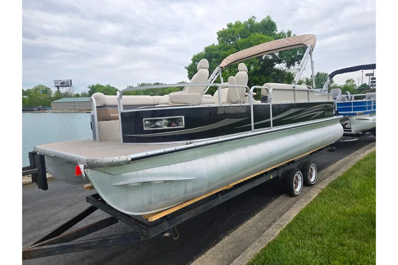 Slide: The Image of 2012 Misty Harbor 2285 Biscayne Bay RL pontoon boat on trailer by a lake. - 8