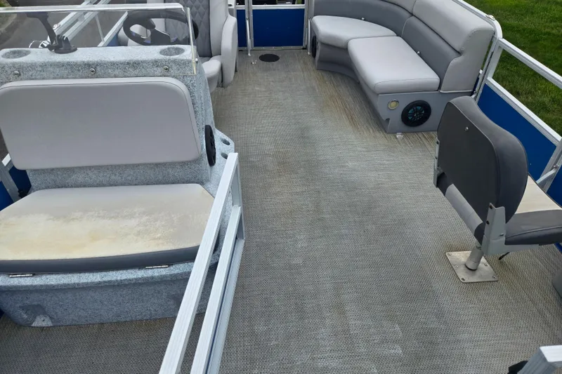 Slide: The Image of Interior of a 2021 Lexington 315 pontoon boat with gray seating and carpeted floor. - 11