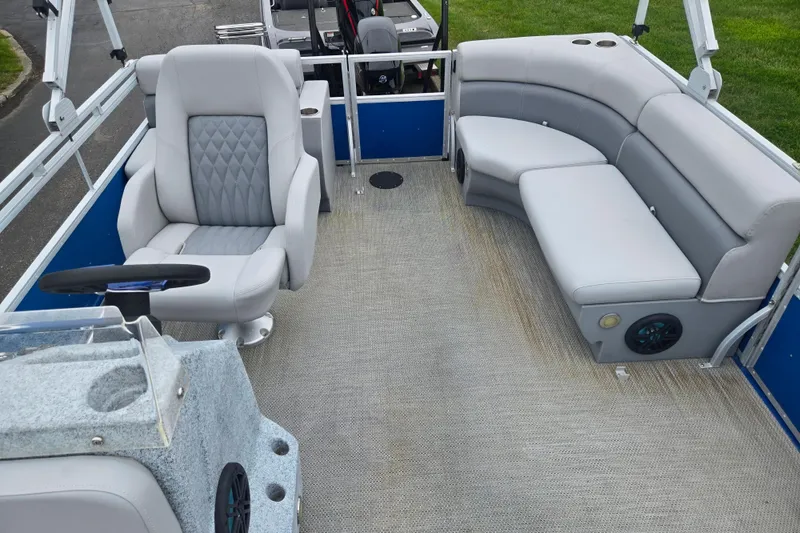 Slide: The Image of 2021 Lexington 315 boat interior with gray seating and steering console. - 13
