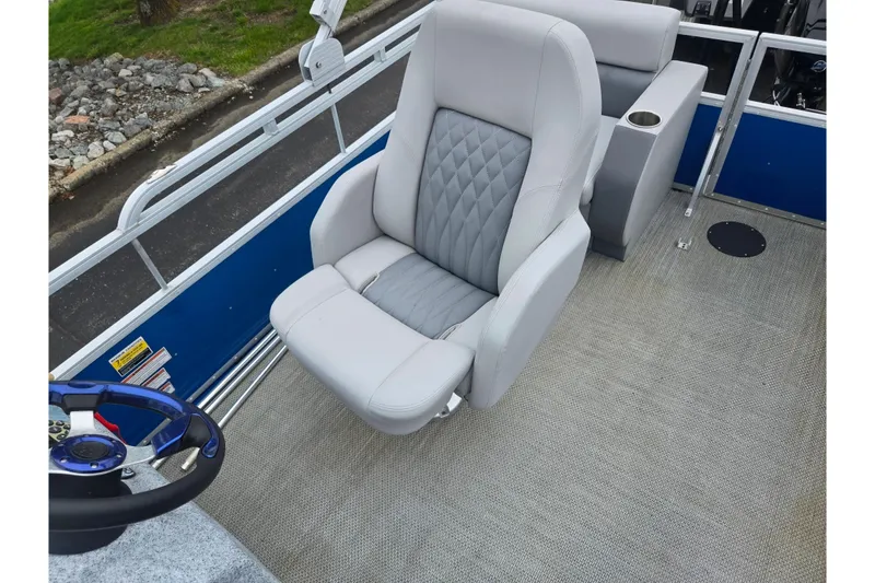 Slide: The Image of 2021 Lexington 315 boat interior with plush captain's chair and steering wheel. - 15