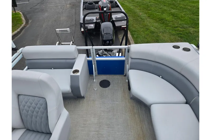 Slide: The Image of 2021 Lexington 315 boat interior with gray seating and cup holders. - 16