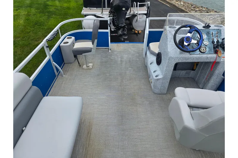 Slide: The Image of 2021 Lexington 315 pontoon boat interior with steering console and seating. - 18