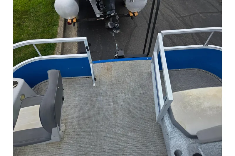 Slide: The Image of 2021 Lexington 315 boat interior with seating and railing, parked on a street. - 21