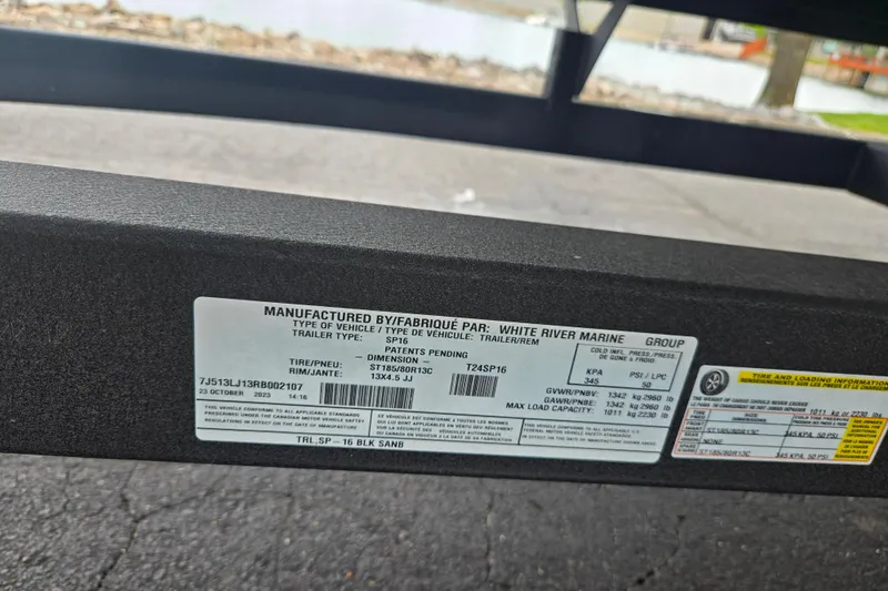 Slide: The Image of Label on a 2021 Lexington 315 trailer by White River Marine, showing specifications and load capacity. - 8