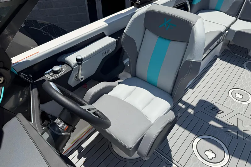 Slide: The Image of 2025 MasterCraft XT24 boat interior with modern steering and seating design. - 11