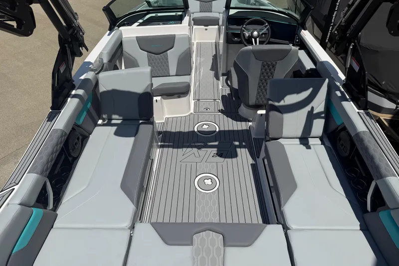 Slide: The Image of 2025 MasterCraft XT24 boat interior with sleek gray seating and modern design. - 13