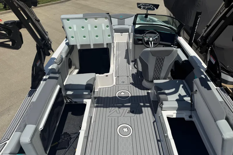 Slide: The Image of 2025 MasterCraft XT24 boat interior with modern seating and sleek design. - 14