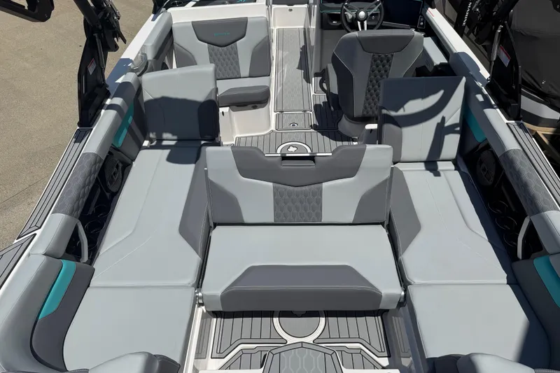 Slide: The Image of 2025 MasterCraft XT24 boat interior with gray seating and modern design. - 18